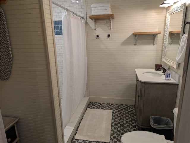 bathroom with tile patterned flooring, toilet, vanity, and a shower with curtain