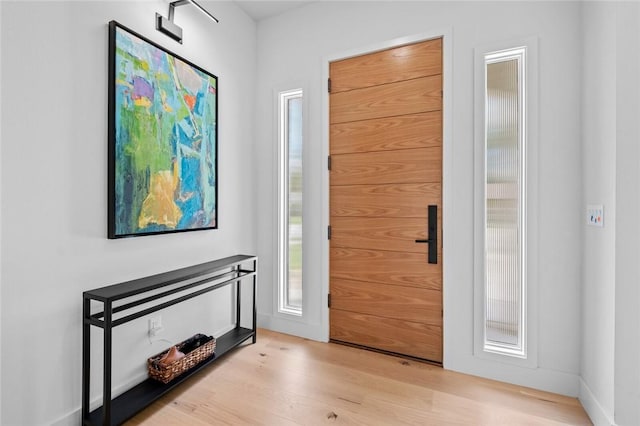 entryway with plenty of natural light and light hardwood / wood-style floors