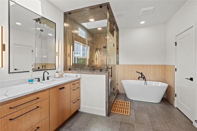 bathroom featuring tile patterned flooring, plus walk in shower, and vanity