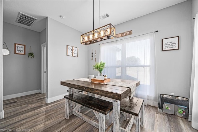 dining area featuring dark wood-style floors, visible vents, and baseboards