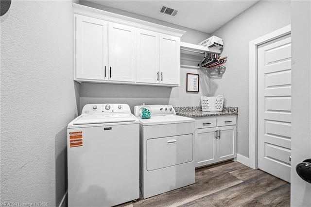 washroom featuring cabinet space, visible vents, dark wood-style floors, and independent washer and dryer