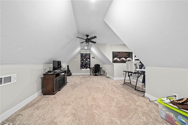 additional living space featuring light colored carpet, visible vents, a textured ceiling, and baseboards