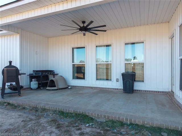 view of exterior entry with a patio area and a ceiling fan