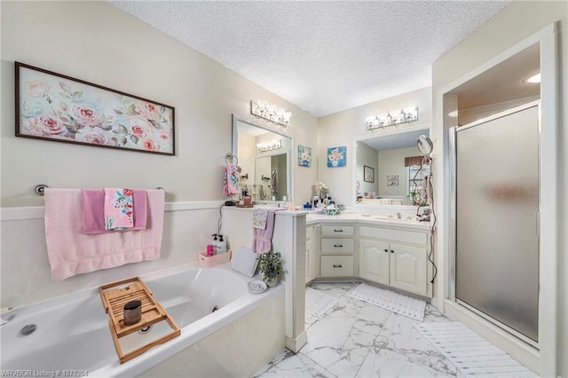 bathroom with marble finish floor, a garden tub, a textured ceiling, vanity, and a shower stall