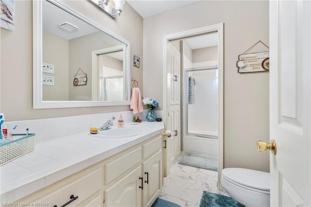 bathroom with toilet, marble finish floor, bath / shower combo with glass door, and vanity