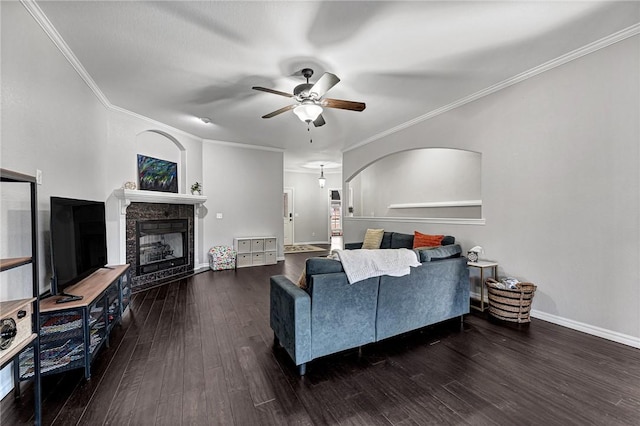 living room featuring crown molding, dark wood-type flooring, and ceiling fan