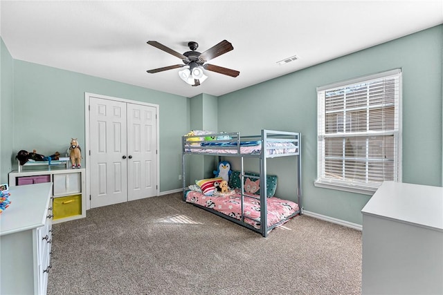 carpeted bedroom with a closet and ceiling fan