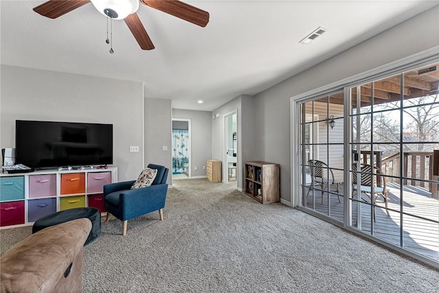 carpeted living room featuring ceiling fan