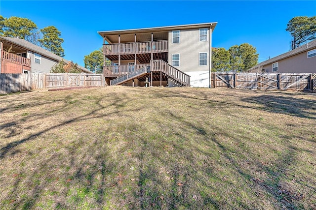 rear view of property featuring a lawn