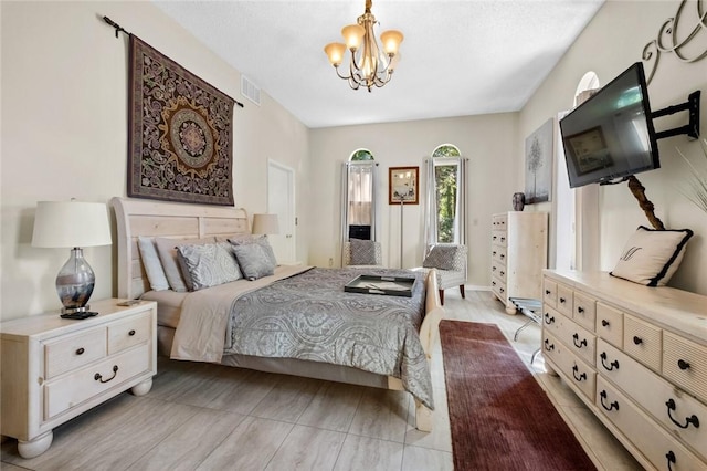 bedroom featuring an inviting chandelier