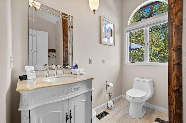 bathroom with vanity, tile patterned floors, and toilet