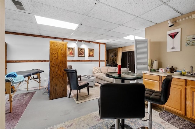 office space with sink and a paneled ceiling