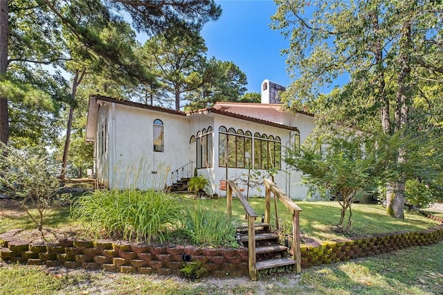 back of house with a yard