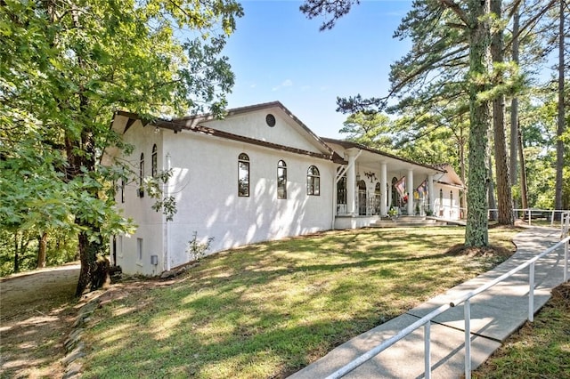 view of side of home with a yard