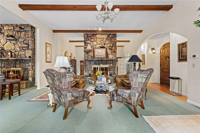 living room with a fireplace, a chandelier, and beam ceiling