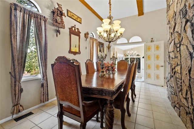 dining area with an inviting chandelier, beam ceiling, and light tile patterned floors