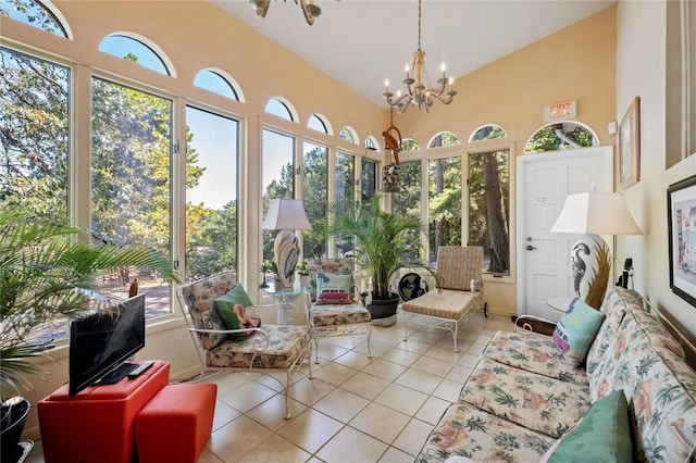 sunroom / solarium featuring an inviting chandelier, vaulted ceiling, and a healthy amount of sunlight