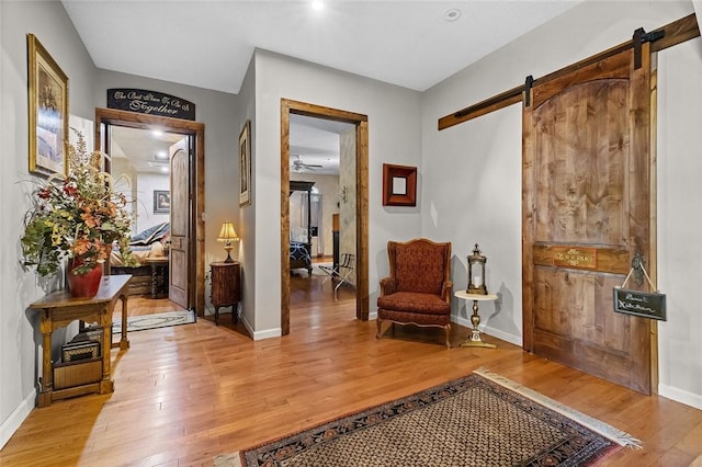 sitting room featuring light hardwood / wood-style floors and a barn door