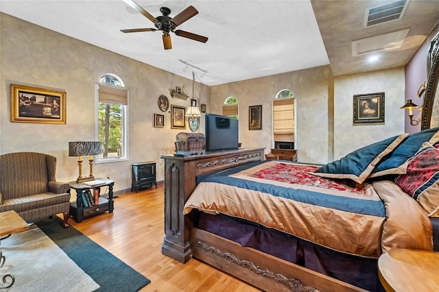 bedroom featuring track lighting and light hardwood / wood-style flooring