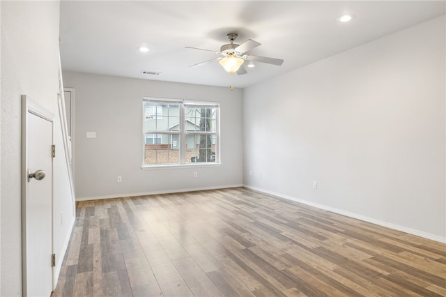 empty room with hardwood / wood-style flooring and ceiling fan