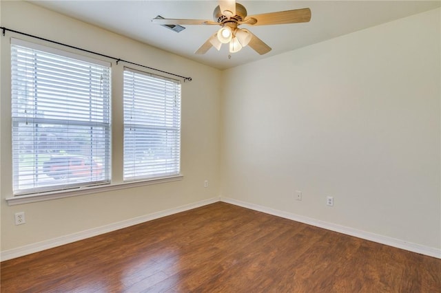 spare room featuring dark hardwood / wood-style floors and ceiling fan