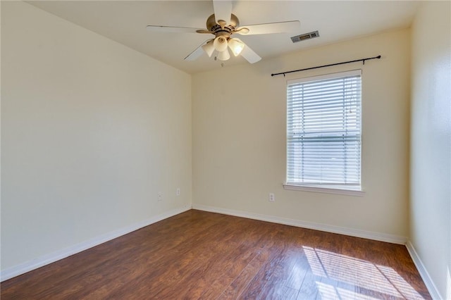 unfurnished room with ceiling fan and dark hardwood / wood-style flooring