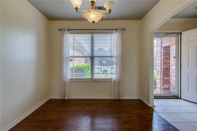 interior space with a notable chandelier and hardwood / wood-style flooring