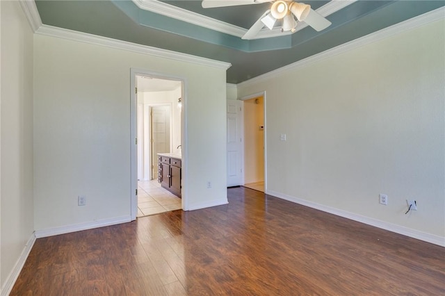 unfurnished room featuring ceiling fan, ornamental molding, a tray ceiling, and light hardwood / wood-style floors