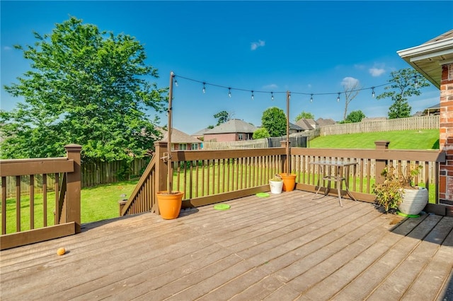 wooden deck with a lawn