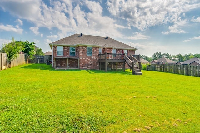 back of house featuring a yard and a deck