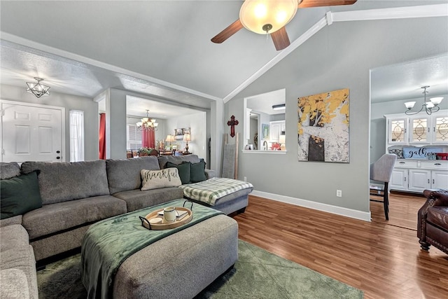 living room featuring hardwood / wood-style floors, ceiling fan with notable chandelier, a wealth of natural light, and high vaulted ceiling