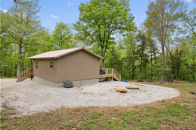 view of property exterior with a wooden deck