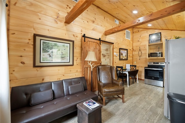 living room with wood ceiling, wood-type flooring, a barn door, and wood walls