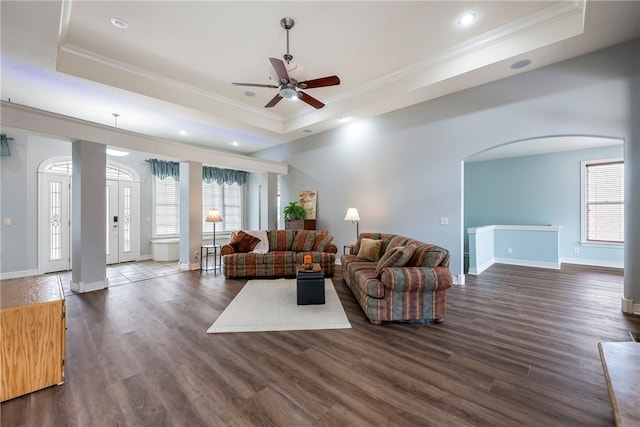 living room featuring crown molding, ceiling fan, dark hardwood / wood-style floors, and a raised ceiling