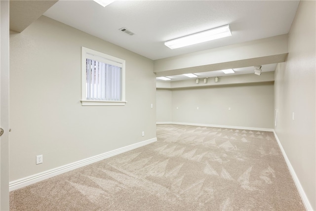 basement featuring light colored carpet