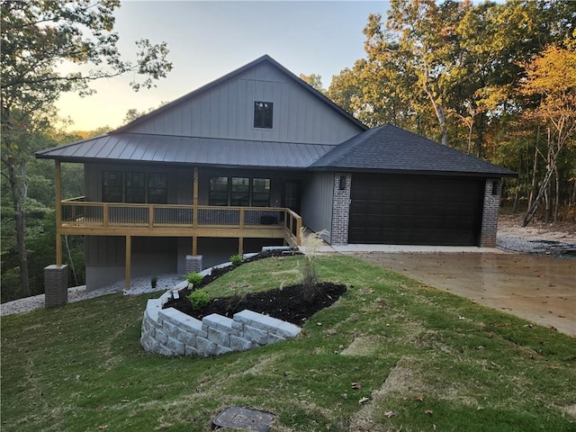 view of front of house with a garage and a yard