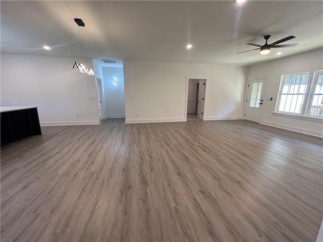 unfurnished living room featuring wood-type flooring and ceiling fan