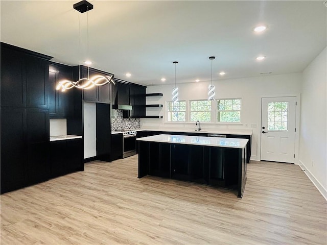 kitchen with hanging light fixtures, a center island, and electric range