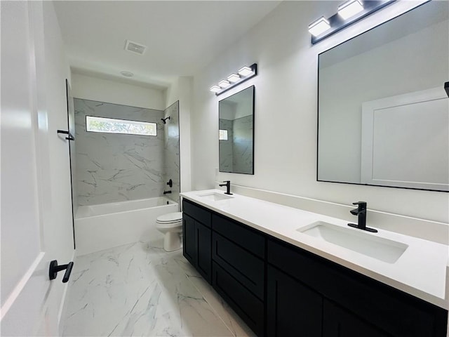 full bathroom with vanity, toilet, and tiled shower / bath combo