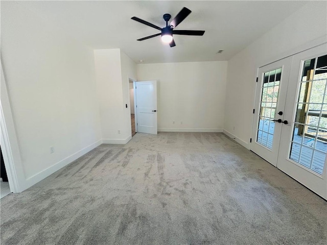 carpeted empty room with french doors and ceiling fan