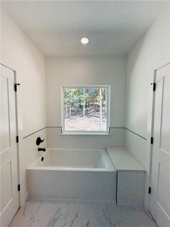 bathroom featuring a tub to relax in