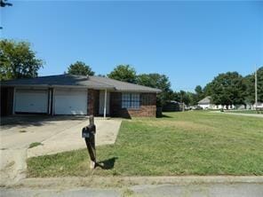 view of front of house with a garage and a front lawn