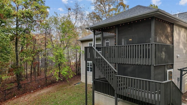 exterior space with a sunroom and a lawn