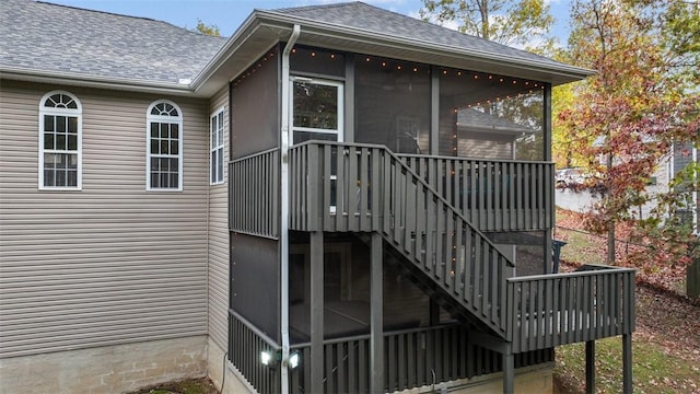 view of property exterior with a deck and a sunroom