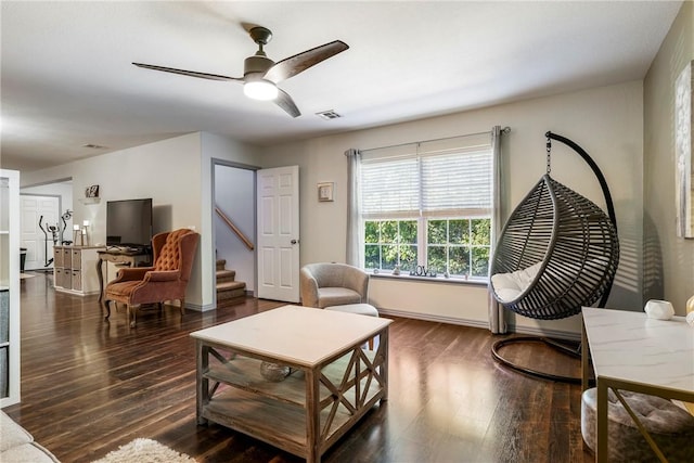 living room featuring ceiling fan and dark hardwood / wood-style flooring