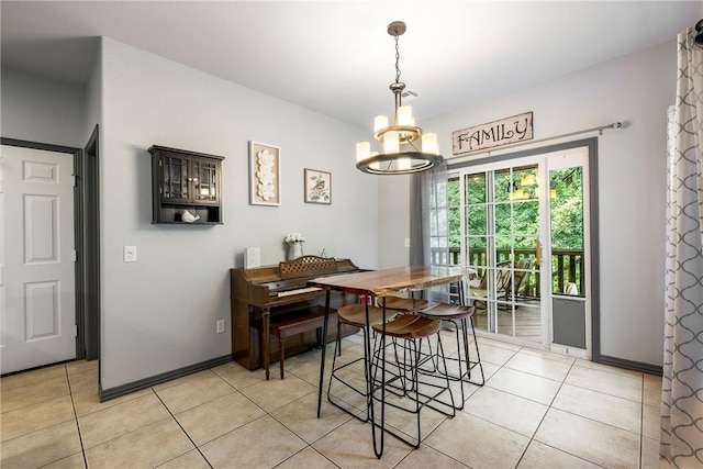 dining area with light tile patterned flooring and a notable chandelier