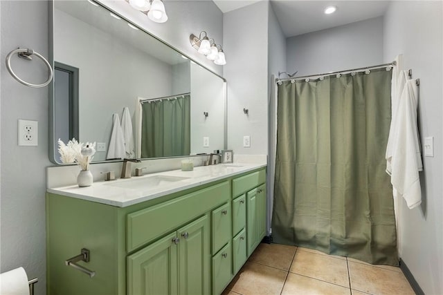 bathroom with shower / tub combo with curtain, tile patterned floors, and vanity