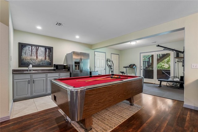 game room featuring pool table, sink, and light wood-type flooring