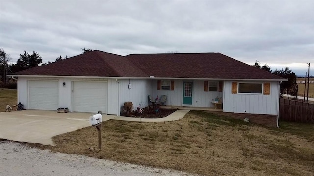 ranch-style house with a garage and a front yard