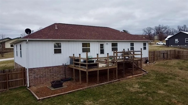 back of house with a yard and a deck